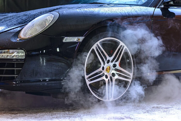 close up of porsche being washed