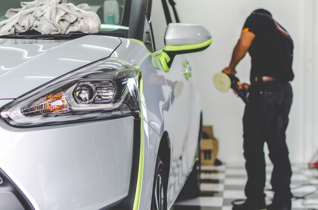 man polishing car exterior