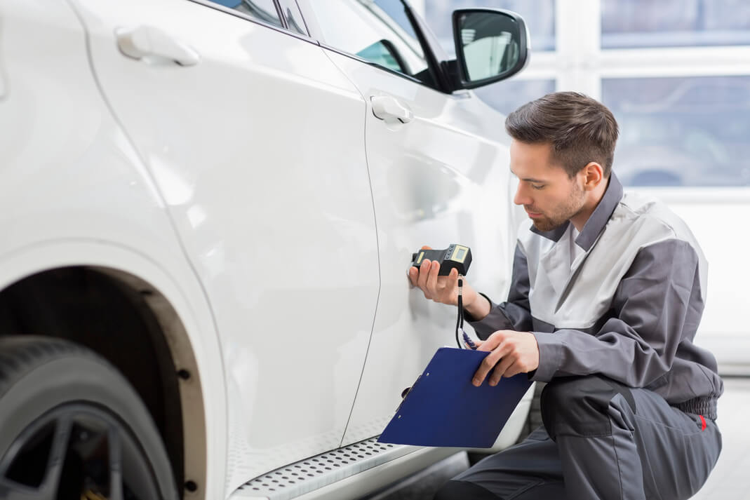 man looking at how to restore faded car paint