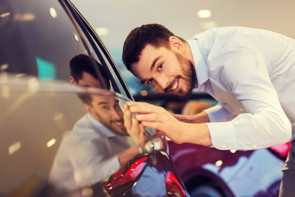 man happy after learning how to detail a car