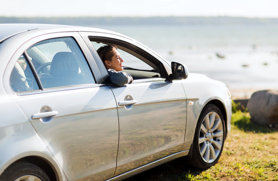  woman inside car enjoying the results of the best car paint sealant