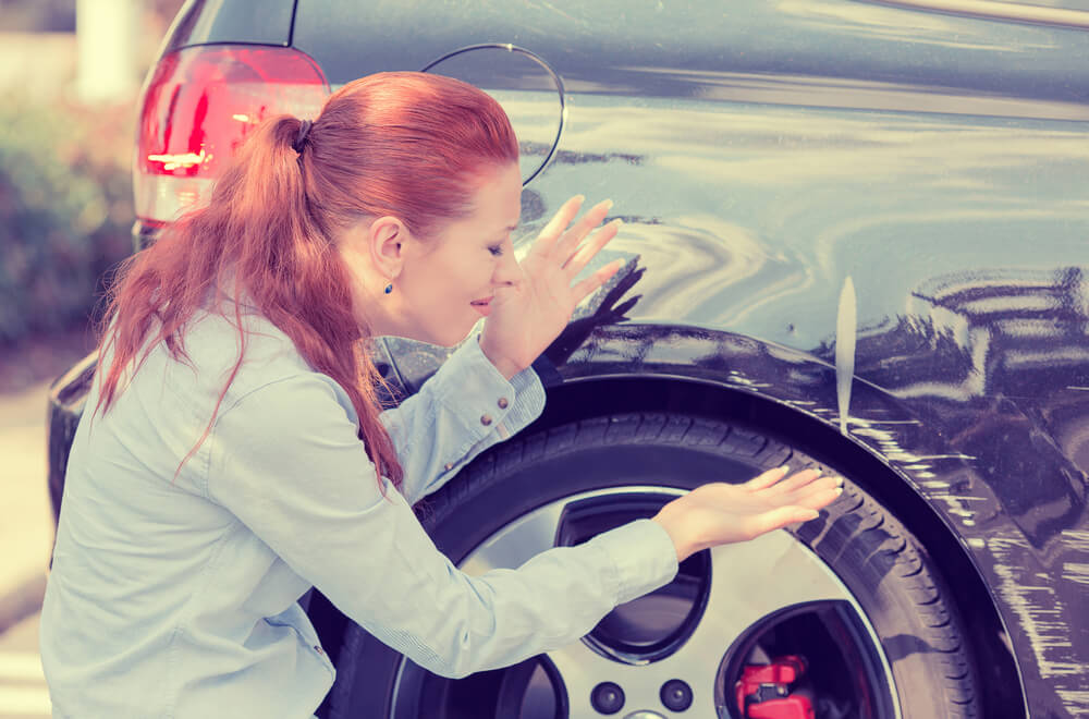 woman worried about how to remove scratches from car