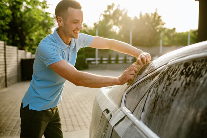 man washing car without harsh chemicals